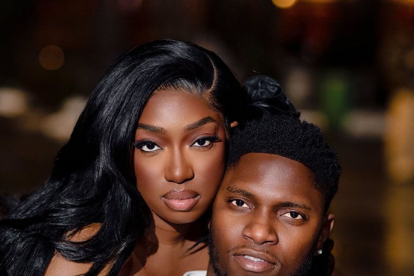 A couple photographed close together in warm light