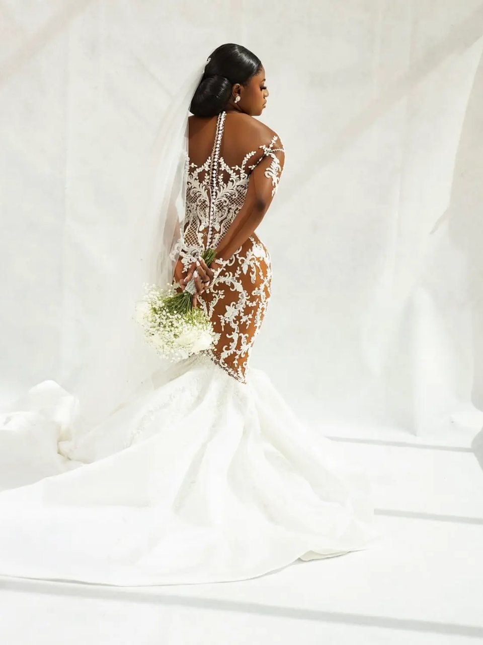 The back of a beaded gown photographed in studio light