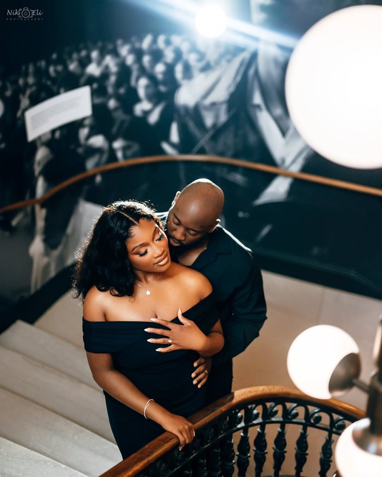 A couple photographed on a staircase in the evening